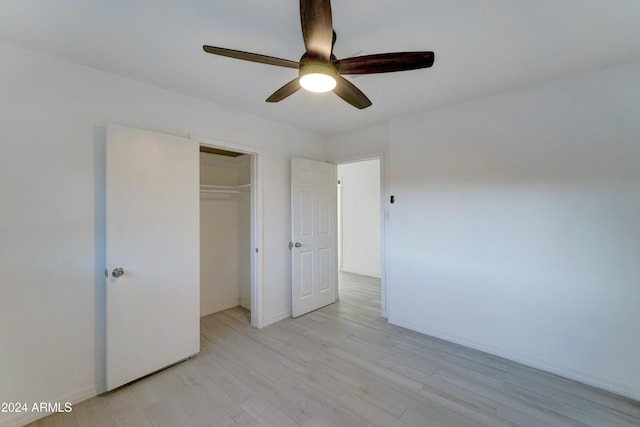 unfurnished bedroom featuring a closet, light hardwood / wood-style floors, and ceiling fan