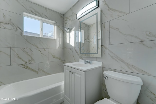 full bathroom featuring vanity, toilet, tile walls, and tiled shower / bath combo