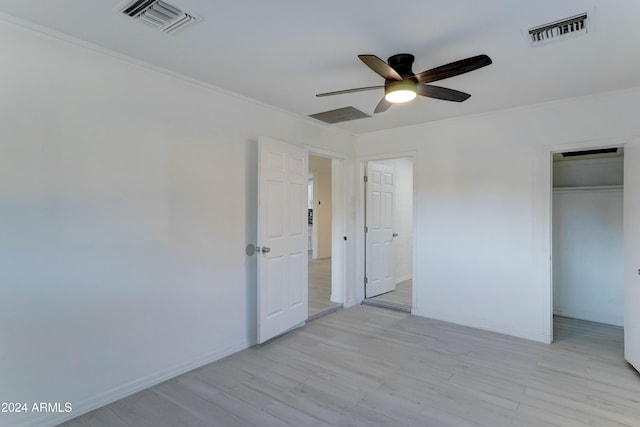 unfurnished bedroom with ceiling fan, a closet, ornamental molding, and light hardwood / wood-style flooring