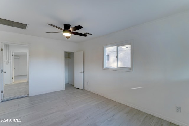 unfurnished bedroom featuring light hardwood / wood-style flooring, ceiling fan, and ornamental molding