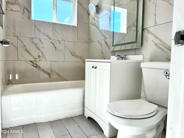 full bathroom with vanity, tiled shower / bath combo, and toilet