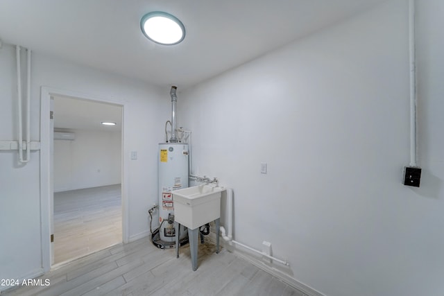 interior space featuring a wall mounted AC, water heater, and sink