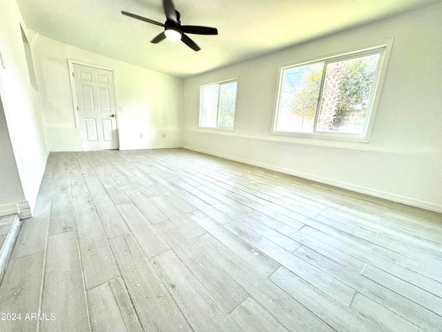 spare room with light wood-type flooring and ceiling fan