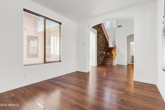 unfurnished living room featuring dark hardwood / wood-style floors