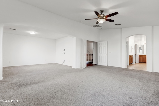 carpeted empty room with ceiling fan