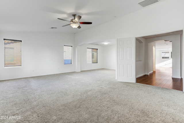 spare room with dark carpet and ceiling fan