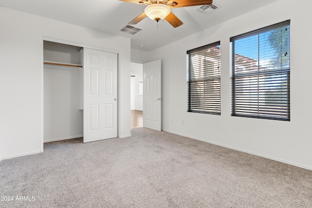 unfurnished bedroom with carpet floors, a closet, and ceiling fan