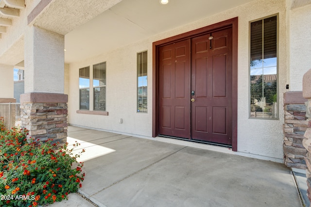 view of exterior entry featuring a porch