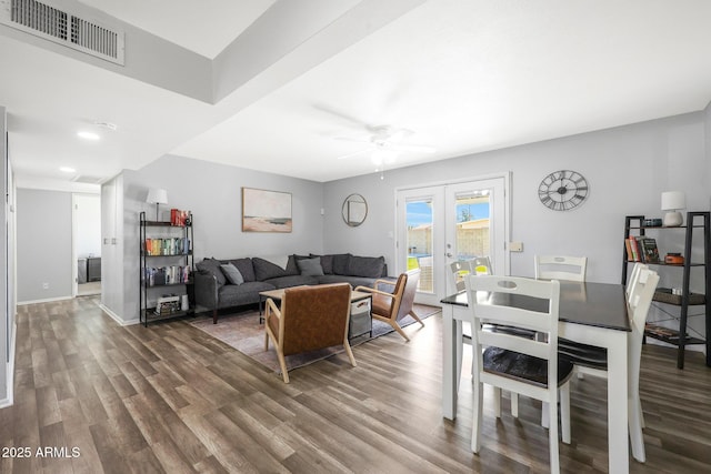 living room featuring dark hardwood / wood-style flooring, french doors, and ceiling fan