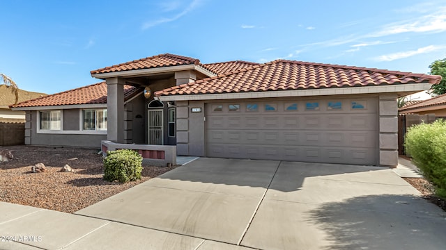 mediterranean / spanish home featuring a garage