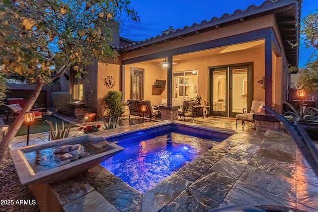 view of pool featuring a hot tub, a patio, and an outdoor fire pit