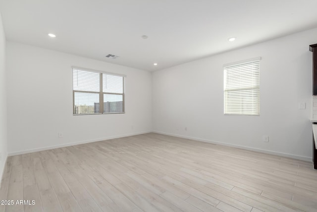 unfurnished room featuring light hardwood / wood-style floors