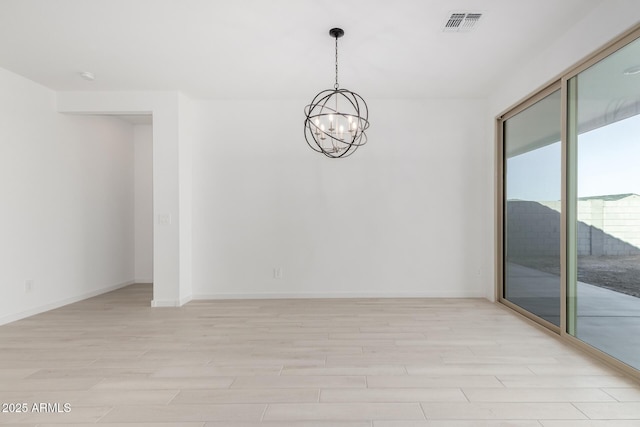 unfurnished room featuring a chandelier and light wood-type flooring