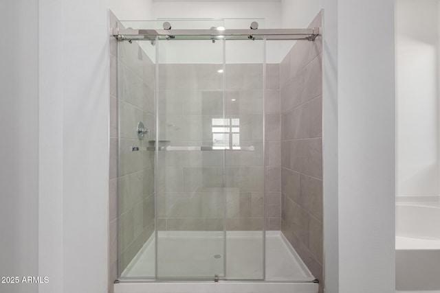 bathroom featuring a shower with shower door