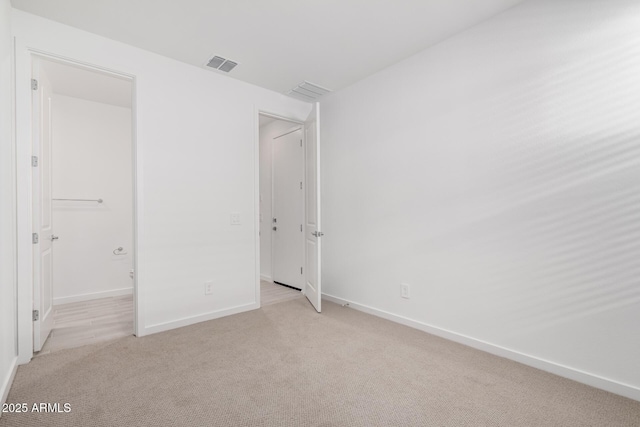 unfurnished bedroom featuring light colored carpet