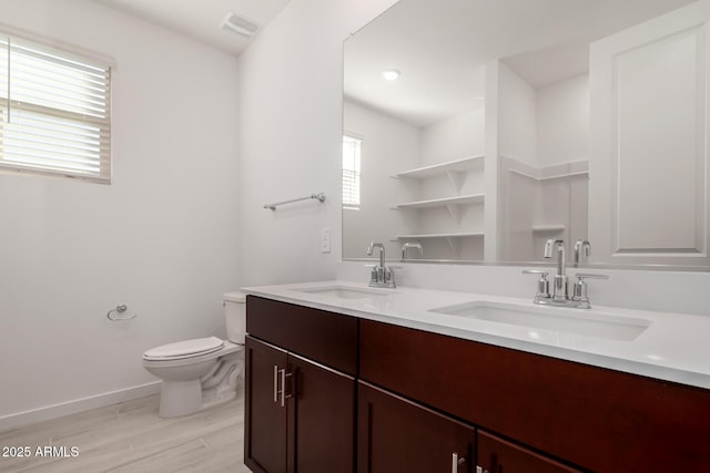 bathroom featuring hardwood / wood-style flooring, vanity, and toilet