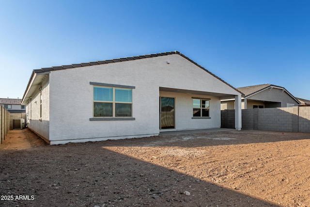 back of property featuring central AC unit