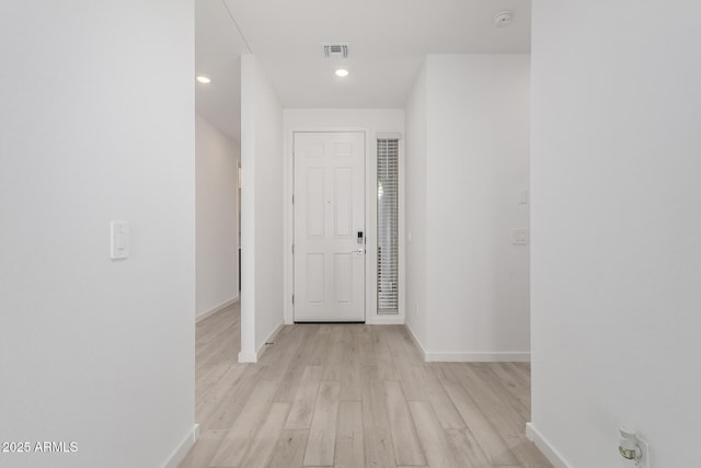 hall with light hardwood / wood-style floors