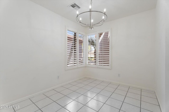 spare room featuring a chandelier