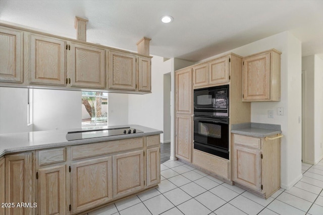 kitchen with light brown cabinets, light tile patterned flooring, and black appliances