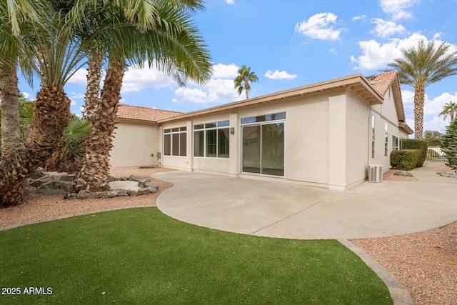 back of property featuring central air condition unit and a patio area