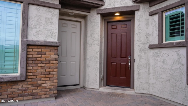 property entrance featuring stucco siding