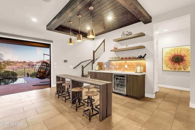 bar featuring wine cooler, stairs, hanging light fixtures, decorative backsplash, and wet bar