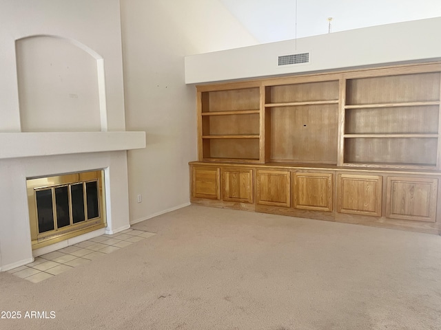 unfurnished living room featuring light carpet