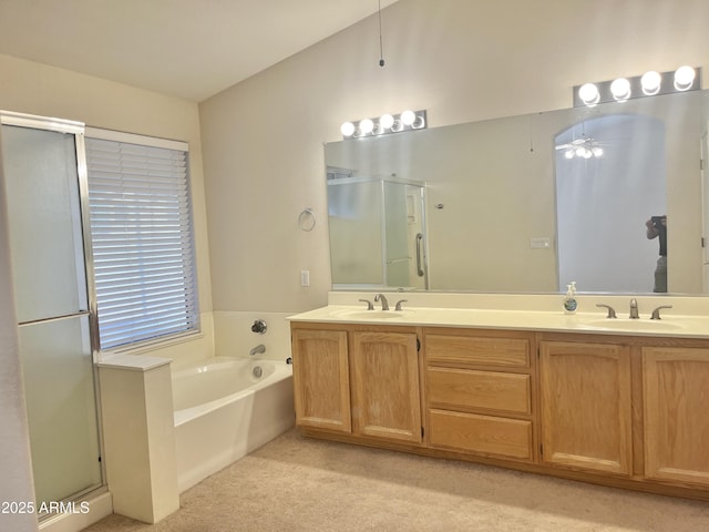 bathroom featuring ceiling fan, plus walk in shower, and vanity