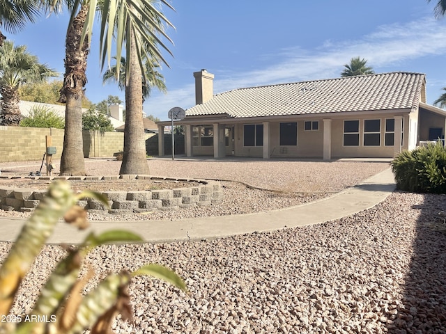 back of property with a patio