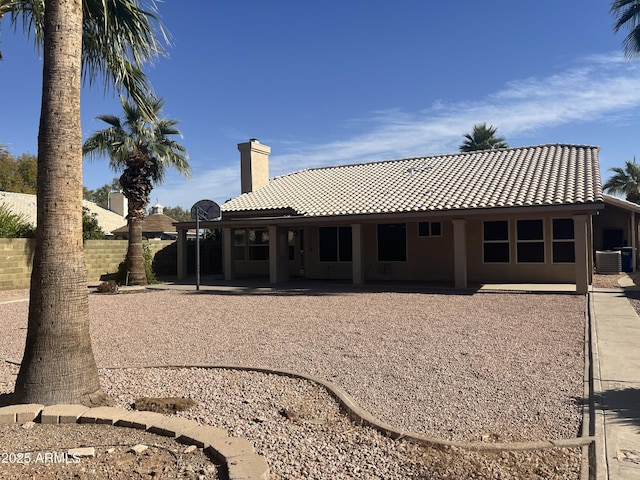 back of property featuring cooling unit and a patio area