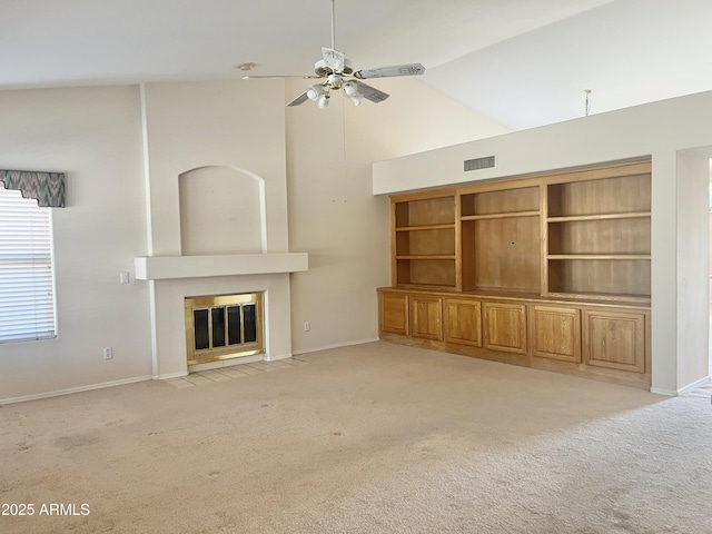 unfurnished living room featuring ceiling fan, high vaulted ceiling, and light carpet