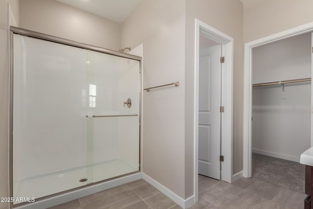 9412 E Sequence Ave, Mesa, AZ 85212 - bathroom with a stall shower, a walk in closet, and tile patterned flooring