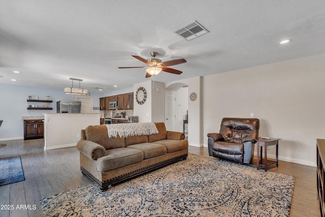308 E Sheffield Ct, Gilbert, AZ 85296 - living room with arched walkways, ceiling fan, wood finished floors, and recessed lighting