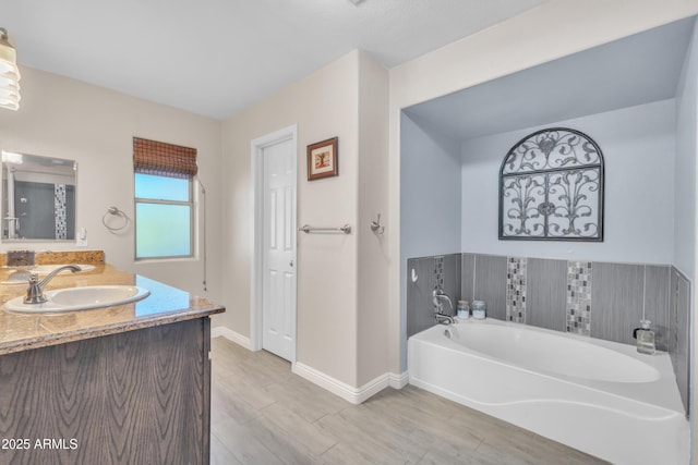308 E Sheffield Ct, Gilbert, AZ 85296 - full bathroom with a garden tub, vanity, and wood finished floors
