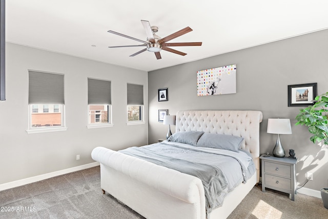 carpeted bedroom featuring a ceiling fan and baseboards