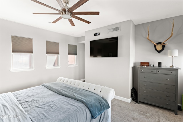 bedroom featuring light carpet, visible vents, a ceiling fan, and baseboards