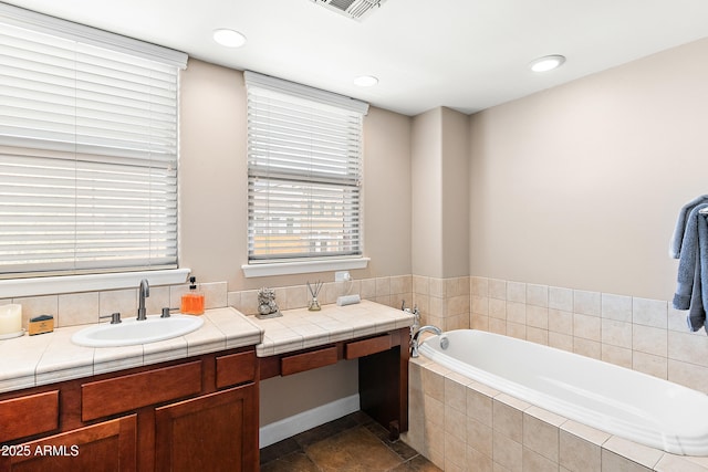 full bath featuring a bath, recessed lighting, visible vents, and a sink