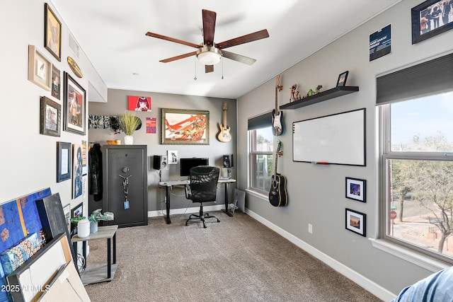 carpeted office featuring a ceiling fan and baseboards