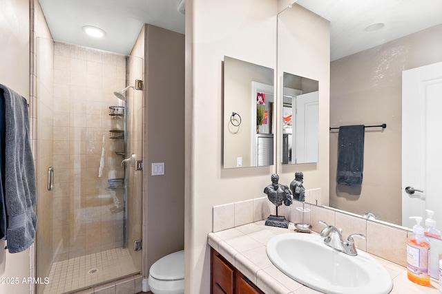 full bath featuring vanity, a shower stall, and toilet