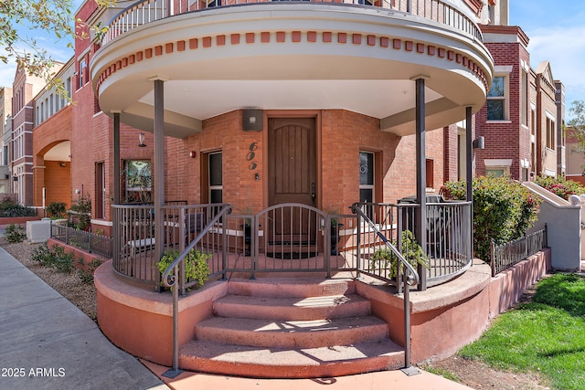 view of front facade featuring brick siding and covered porch