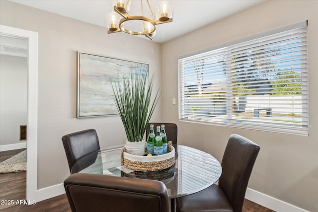 dining room with an inviting chandelier and dark hardwood / wood-style floors