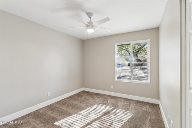 carpeted spare room featuring ceiling fan