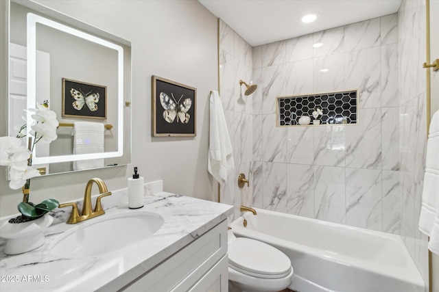 full bathroom with vanity, tiled shower / bath combo, and toilet