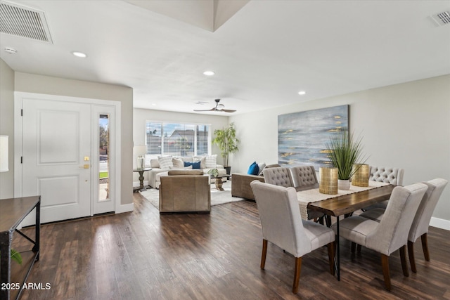 dining area with ceiling fan and dark wood-type flooring