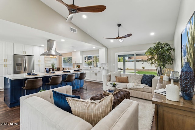 living room with ceiling fan, lofted ceiling, and dark hardwood / wood-style floors