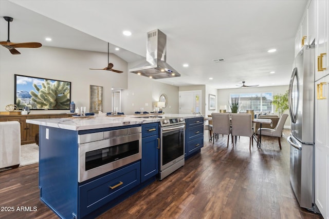 kitchen with island range hood, stainless steel appliances, blue cabinetry, light stone counters, and a spacious island