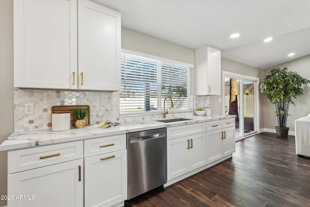 kitchen featuring dark hardwood / wood-style floors, sink, white cabinetry, stainless steel dishwasher, and backsplash