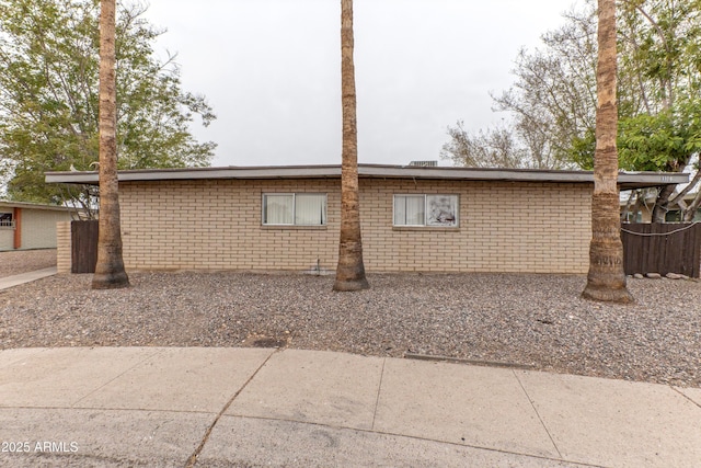 view of side of property featuring brick siding