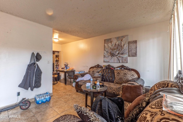 living area with a textured ceiling and light tile patterned flooring